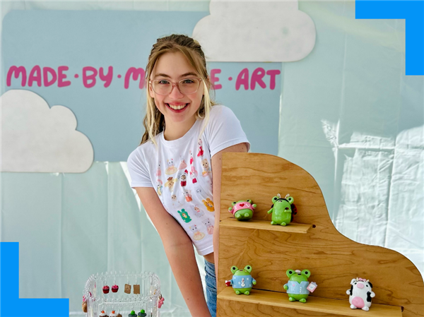  Mabel stands in a booth with her creations.